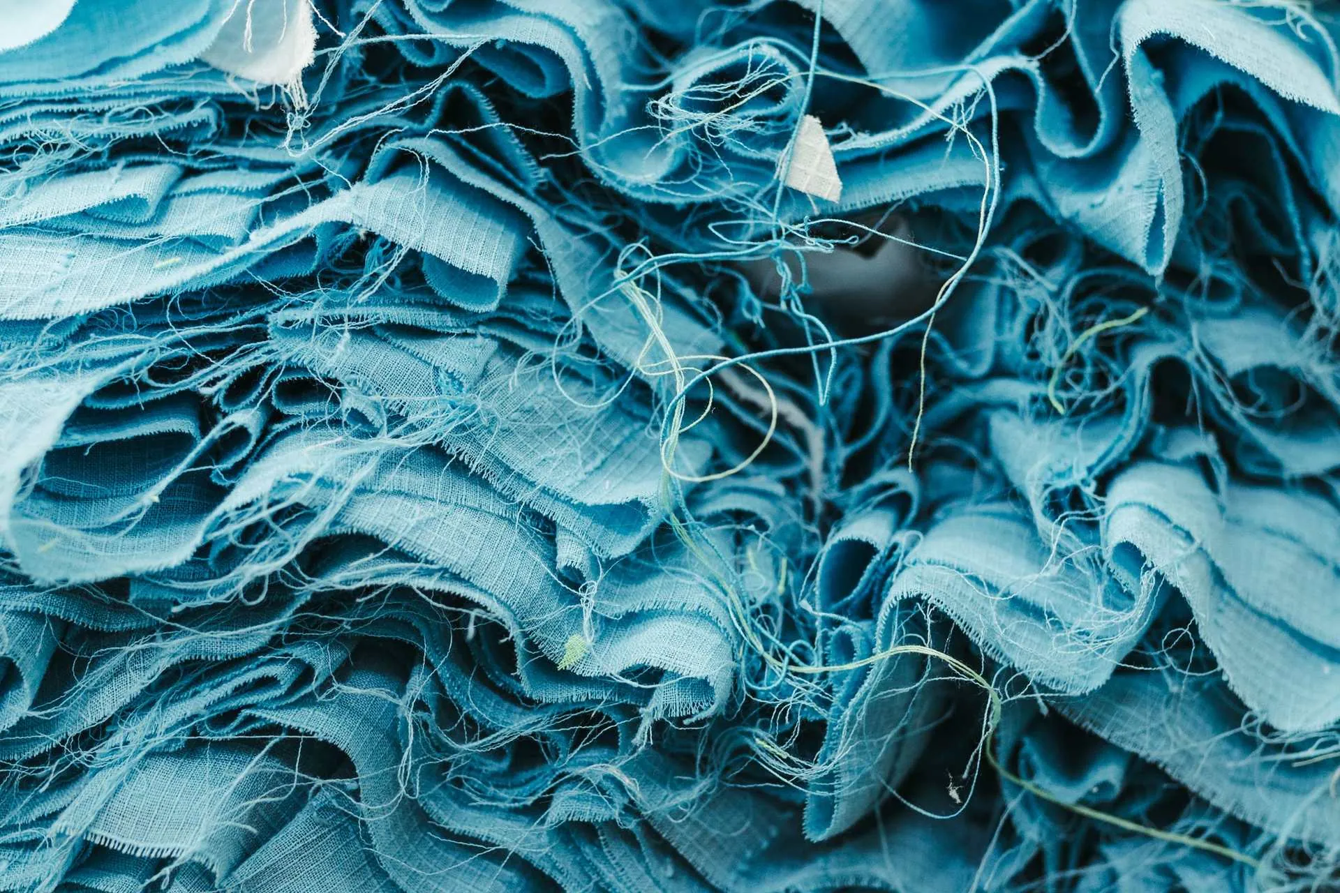 Close-up of crumpled blue fabric with loose threads, textile texture for sublimation printing