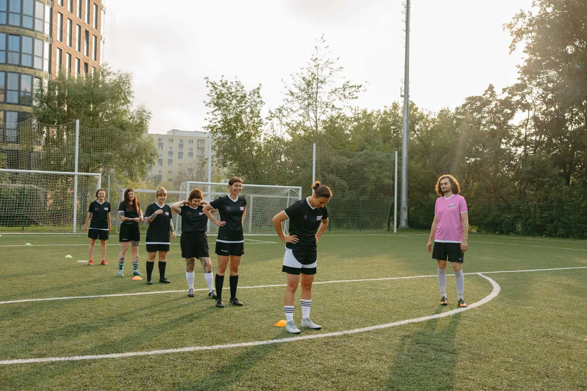Football team lined up on a training pitch, teamwear in action