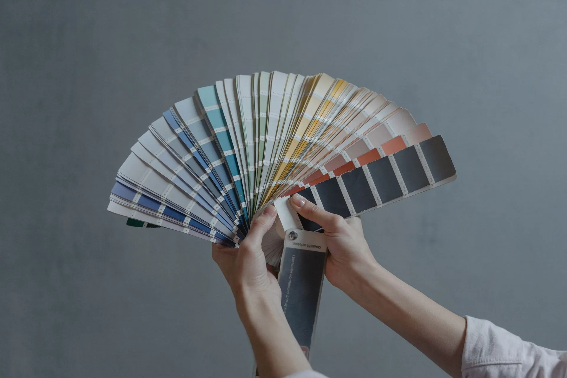 Hand fanning open a colour swatch book for sublimation colour matching