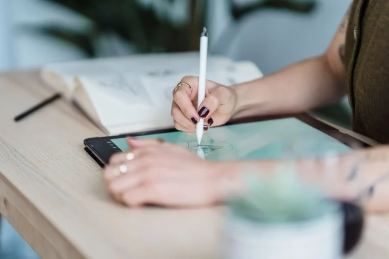 Designer sketching a garment on a tablet with a stylus, AI sportswear design workflow