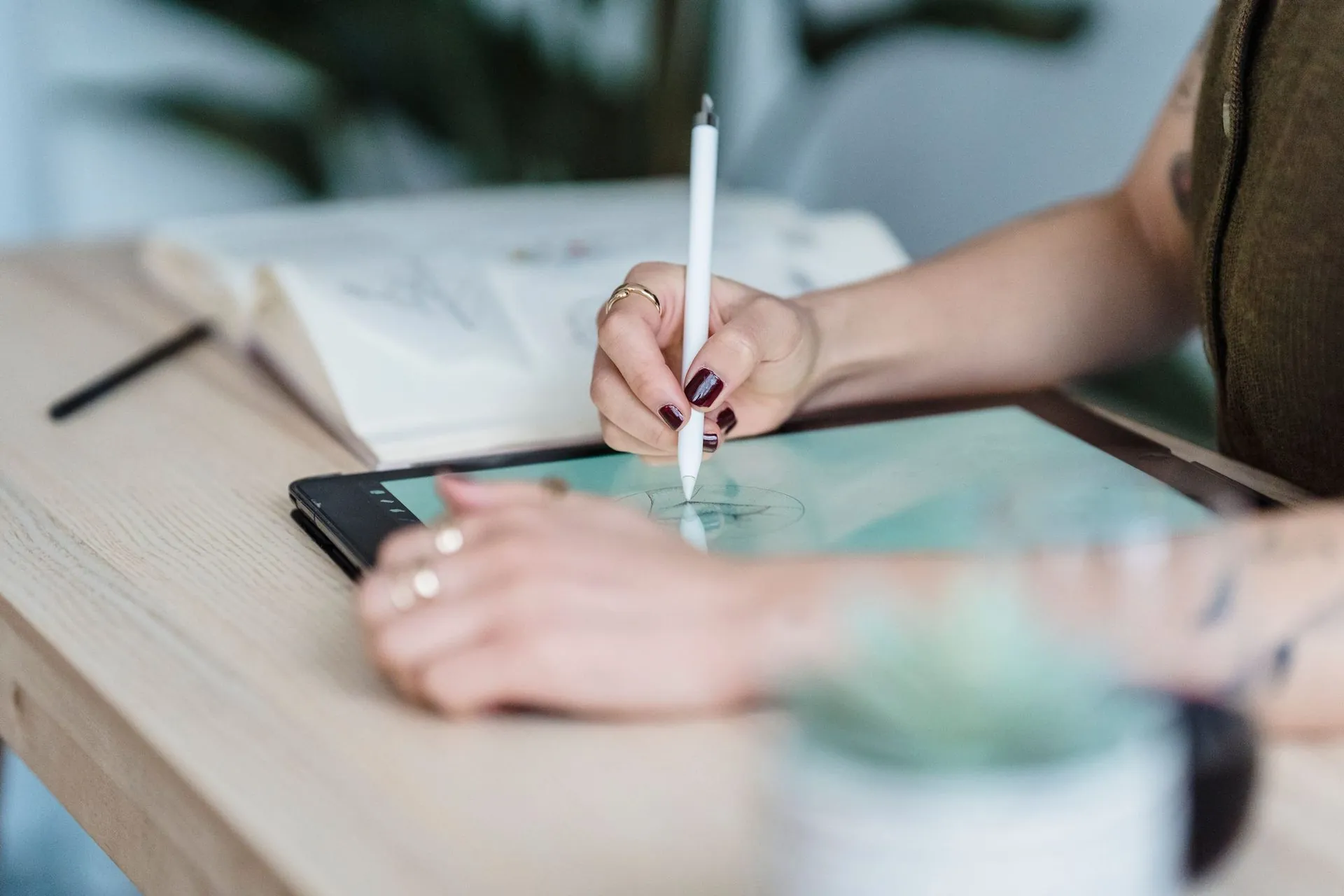 Designer sketching a garment on a tablet with a stylus, AI sportswear design workflow