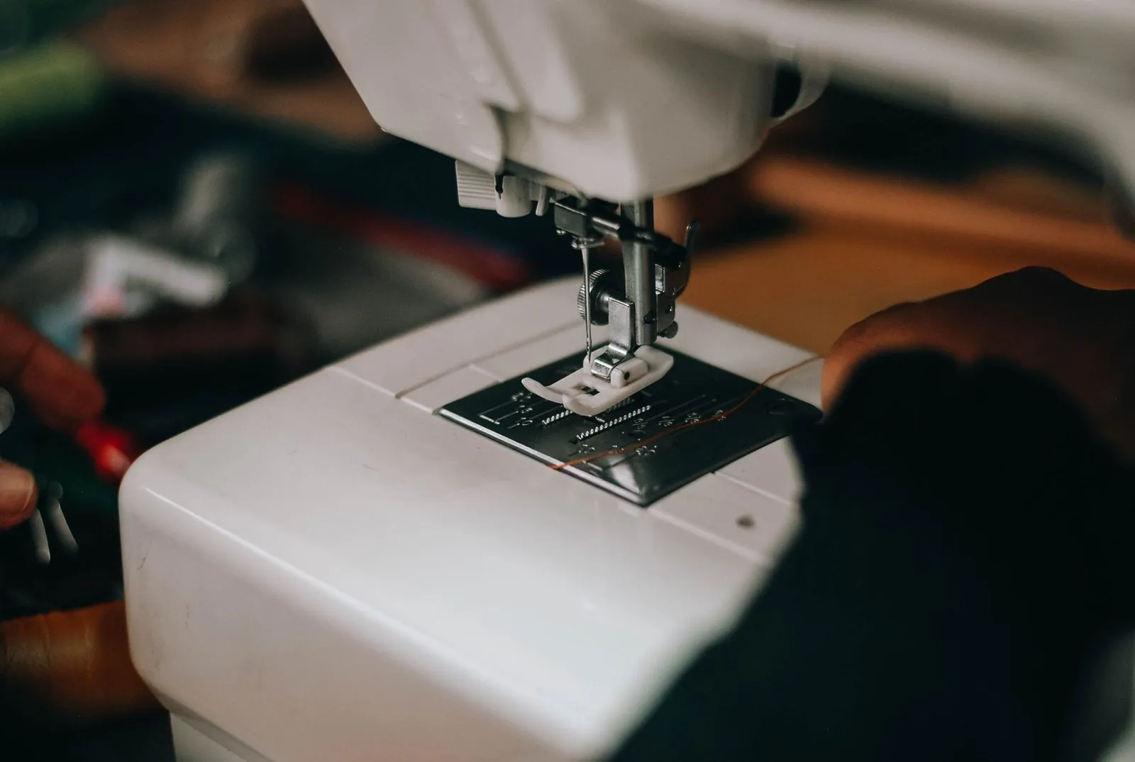 Close-up of a sewing machine needle stitching fabric during running apparel sampling