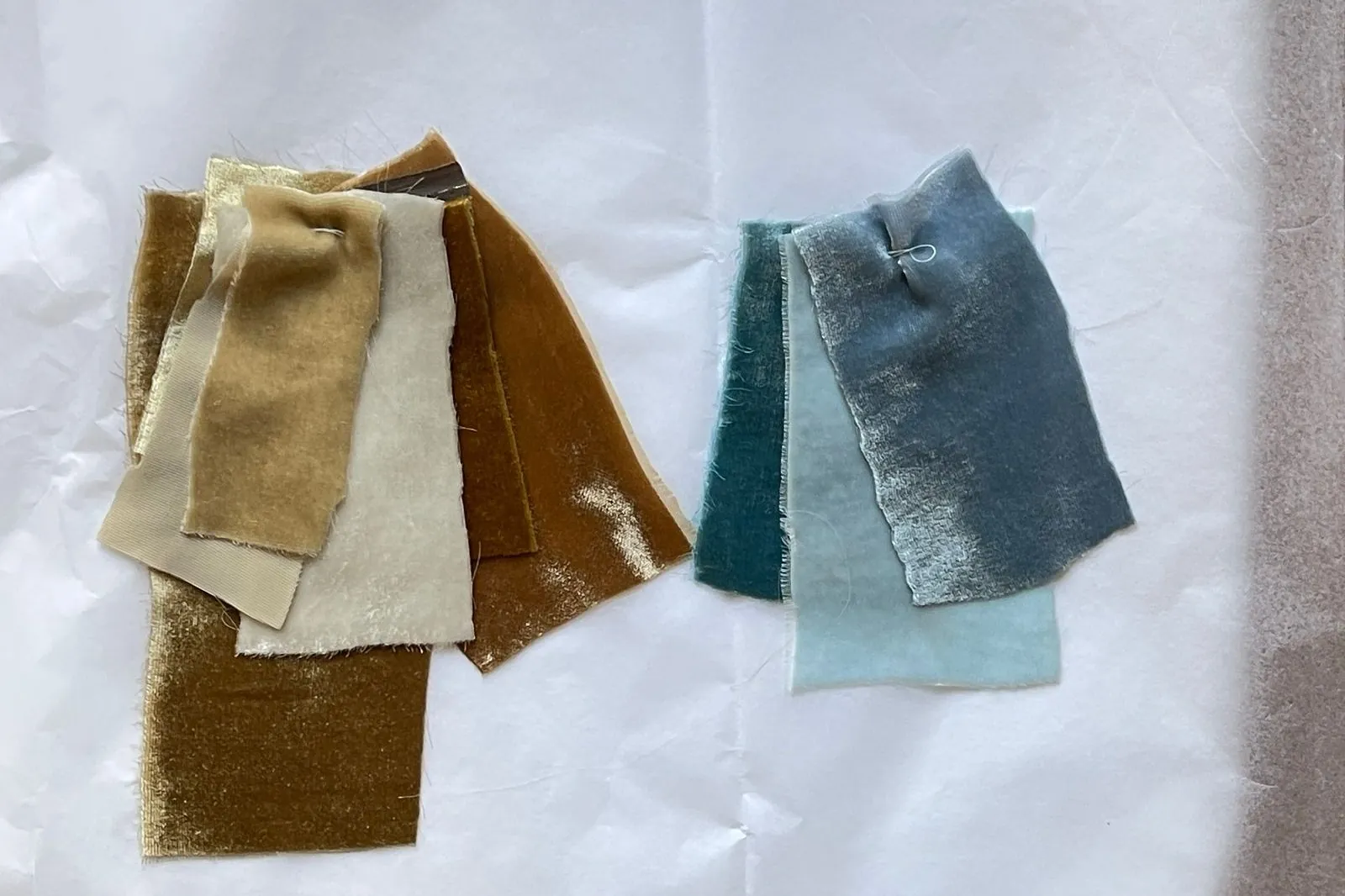 Blue and gold fabric colour swatches laid out for choosing a sublimated swim rashguard palette
